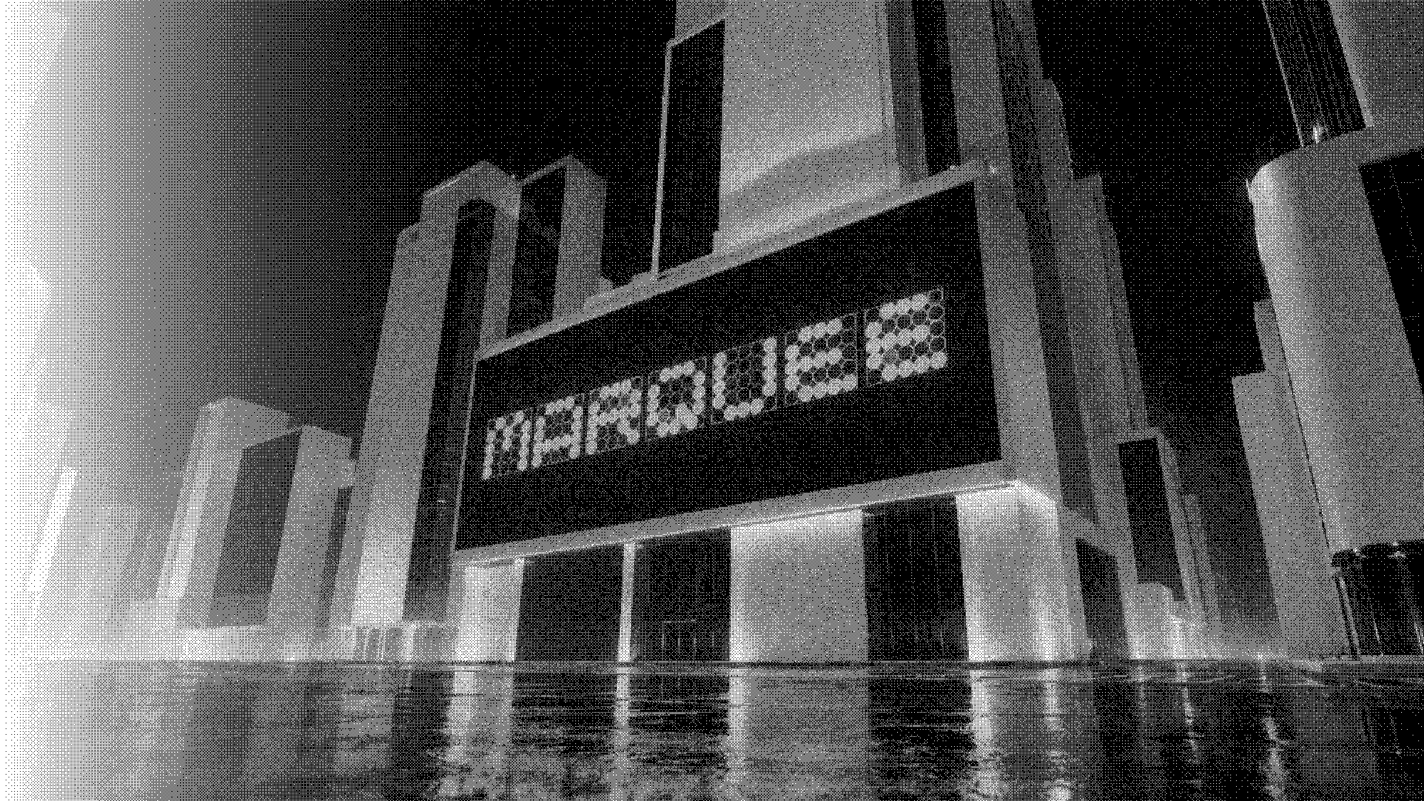 The MARQUEE billboard on a white city at night, rendered as a one-bit halftone